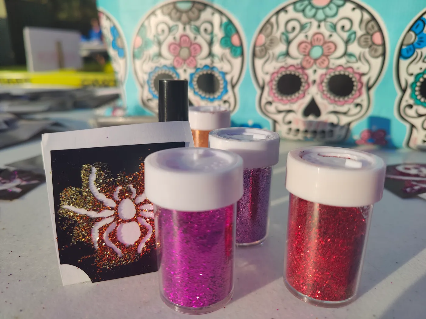 Small containers of colorful glitter on a table